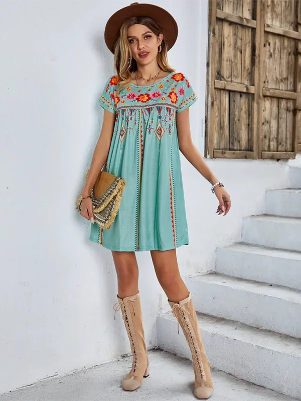 Alt text: "Nihira - Embroidered boho mini dress in lightweight cotton with intricate stitching and tassel ties, perfect for…