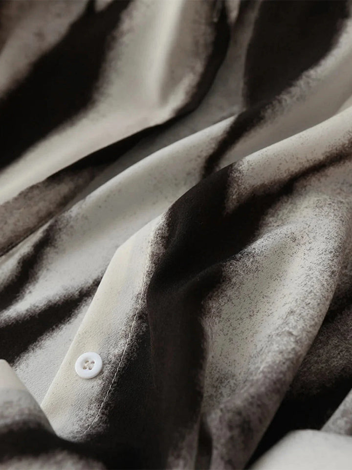 "Abstract print button-up blouse in soft chiffon fabric, with a stylish and modern design by Alaska."
