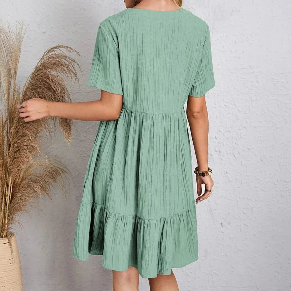 "Atzi mini dress with a flattering V-neck and charming ruffle hem detail, perfect for a casual yet stylish look."