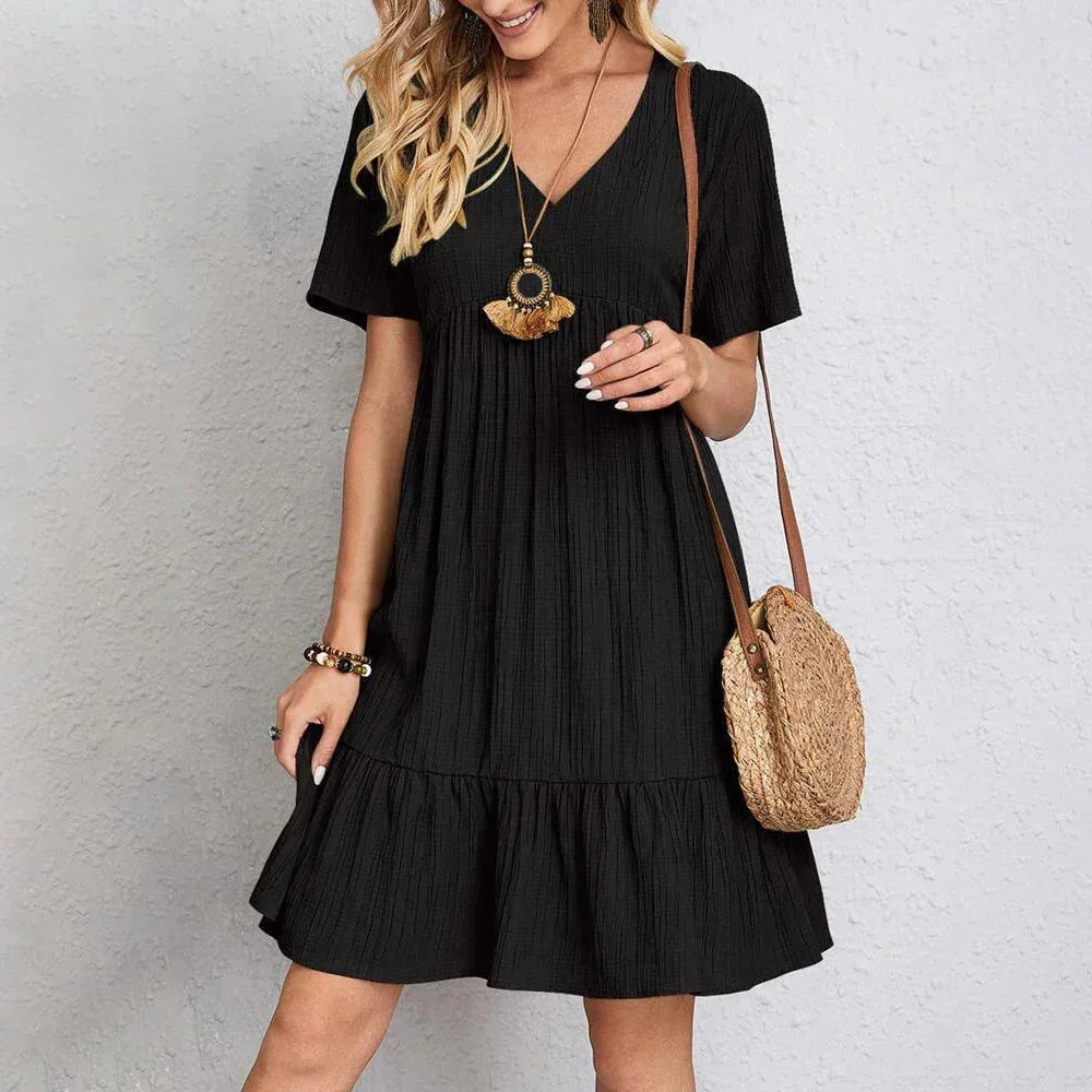 "Atzi V-neck mini dress in ivory, featuring delicate ruffle hem and made with lightweight cotton blend fabric."