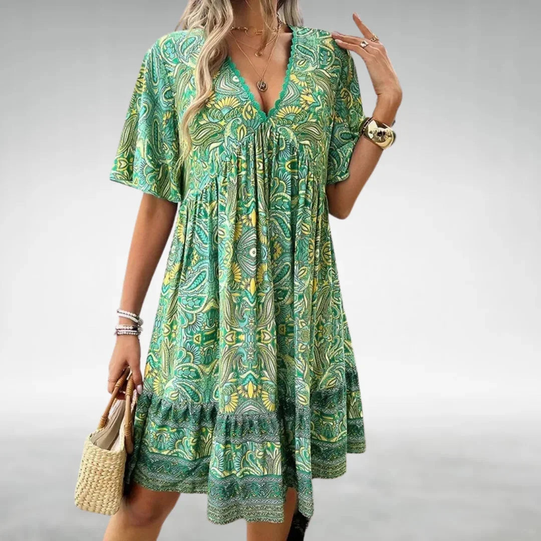 "Erica relaxed-fit boho mini dress in soft cotton with embroidered details and flowy silhouette."