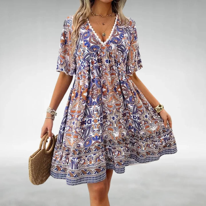 Blue Erica dress with a relaxed fit and boho style. Made of lightweight fabric with floral print and flowy silhouette.