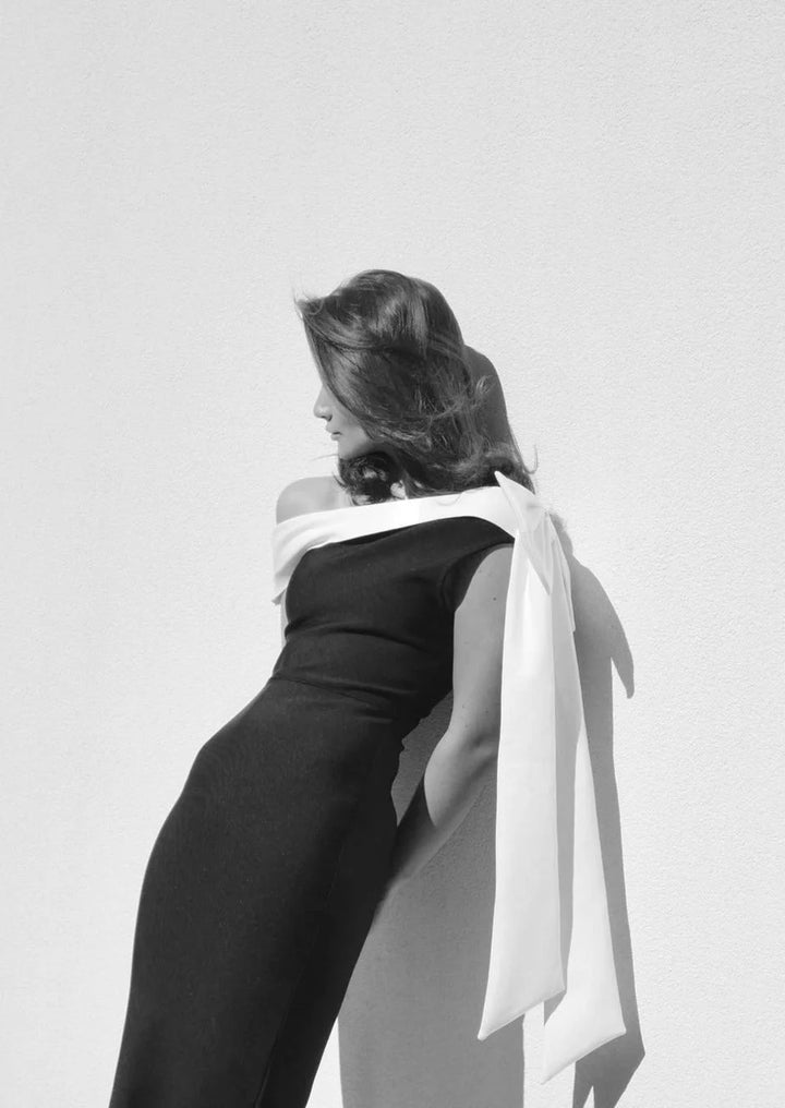 Black and white midi dress featuring asymmetrical design, ideal for a bold and modern look.
