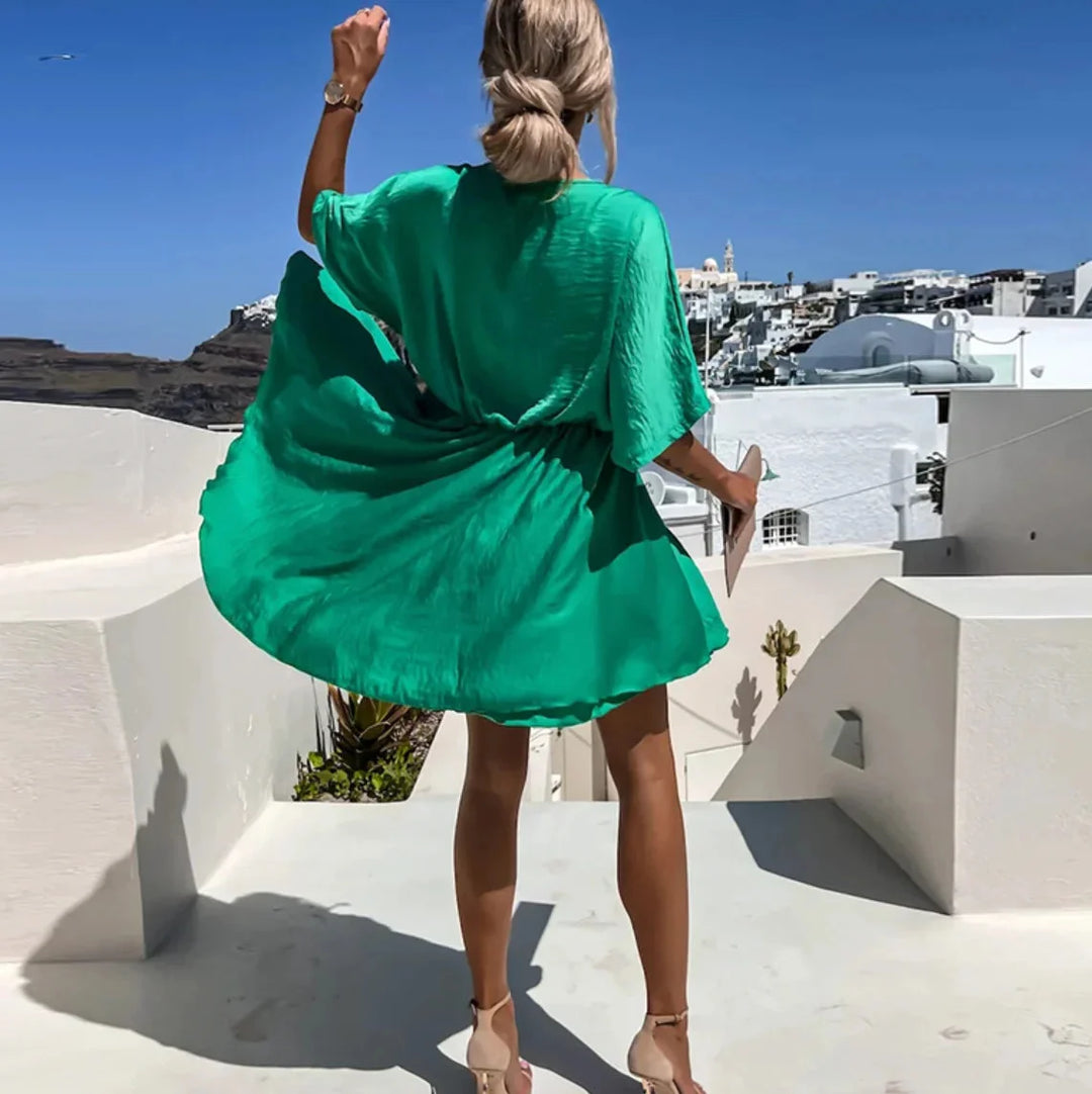 "Leandra flowy mini dress in a soft, breathable fabric with a flattering V-neck design for a casual yet chic look."