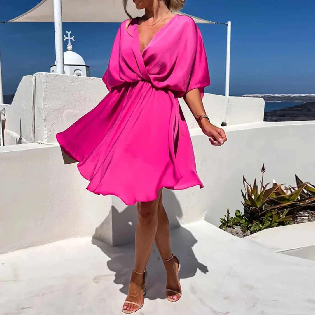 "Flowy v-neck mini dress in Leandra color with a relaxed fit and breezy silhouette, perfect for a casual day out."