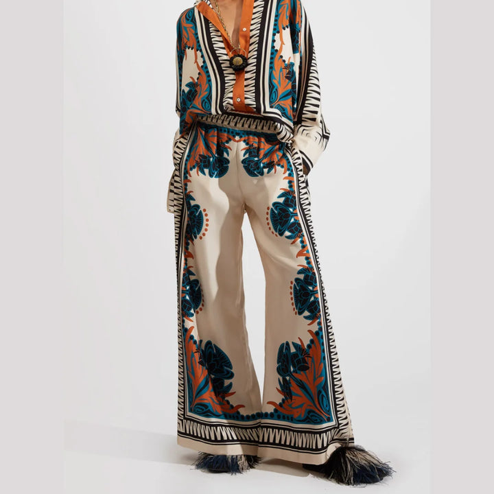 "Orange Aryiah bohemian set featuring lightweight fabric, floral patterns and tassel details for a trendy spring look."