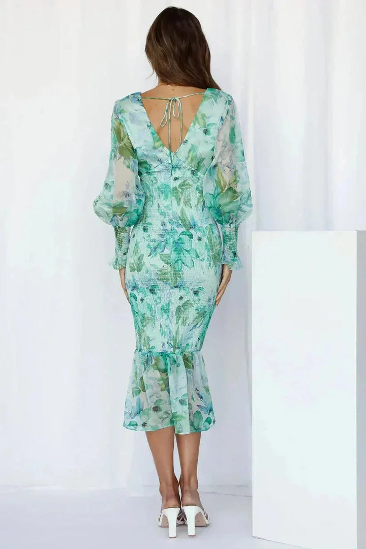 Women's ruched midi dress with flare hem in soft, flowy fabric. Features flattering ruching detail and elegant midi length.