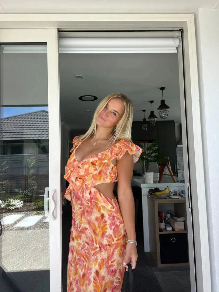 "Kaelynn midi dress with V-neckline and floral ruffle design, crafted from lightweight and breathable fabric." 🔆