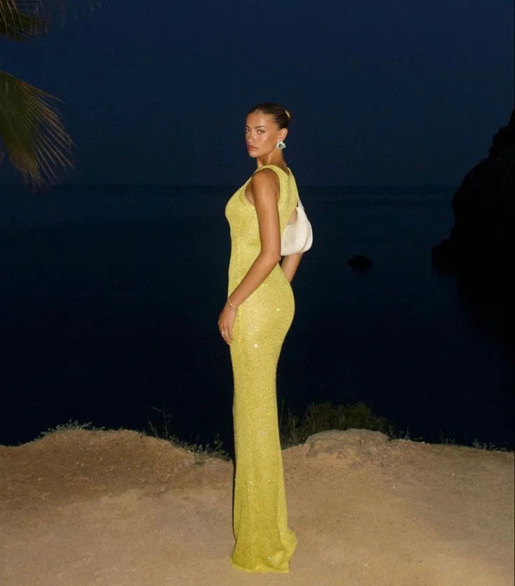 "Jacquelyn sleeveless maxi dress in sparkling fabric, perfect for evening events"