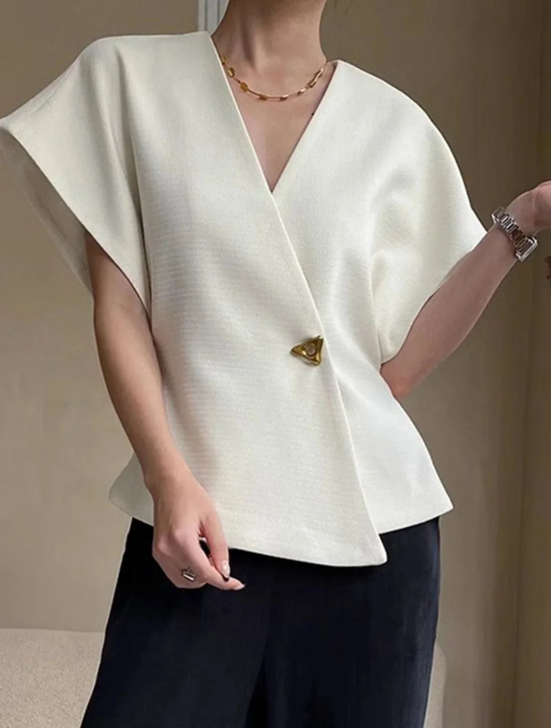"Landrie blouse in wrap style, sculpted sleeves. Soft fabric and elegant design for chic look."