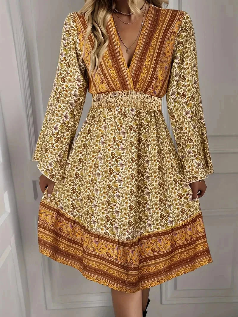 Mazie boho pattern plus-size mini dress with bell sleeves in a detailed colorful print on flowy fabric.