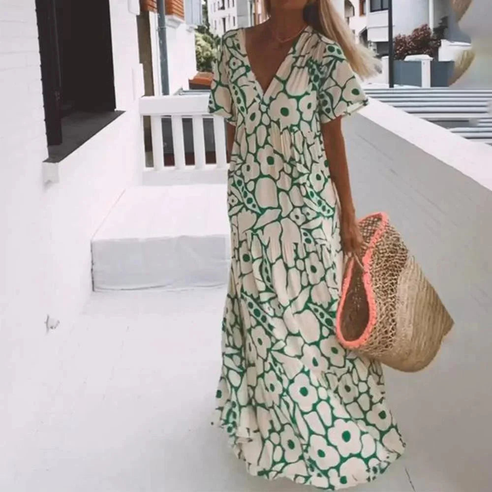 "Acacia maxi dress in floral print with cap sleeves. Soft and flowy fabric, perfect for sunny days and casual gatherings."