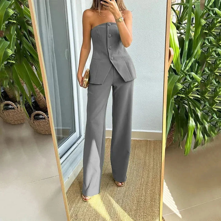 "Rori strapless top and high-waisted pants set in black, featuring ribbed knit fabric with a figure-hugging silhouette."