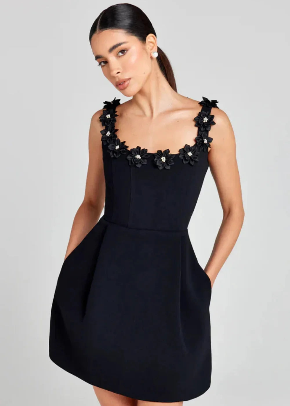"Black mini dress featuring white floral embroidery on lightweight fabric - Auriella collection"