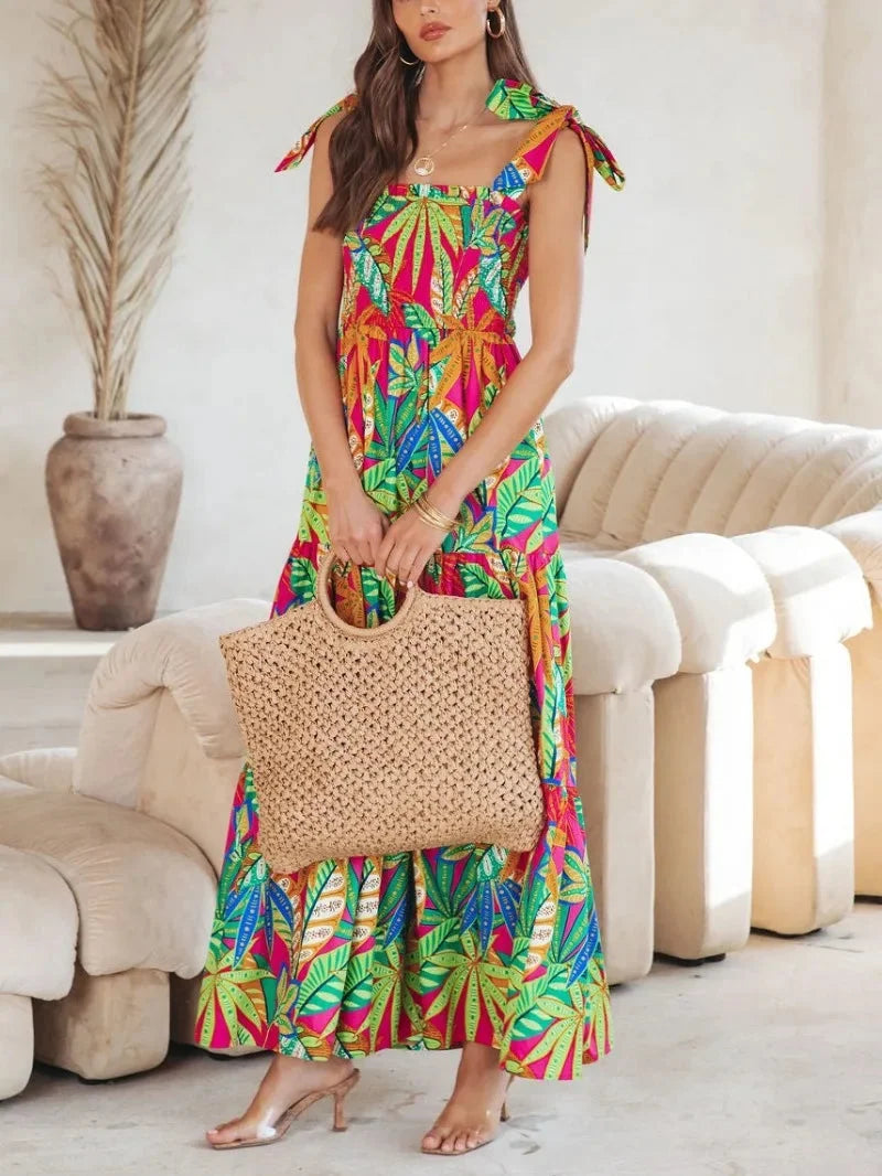 Green sleeveless maxi dress with a tropical print design, perfect for summer outings. Made from breathable and lightweight…