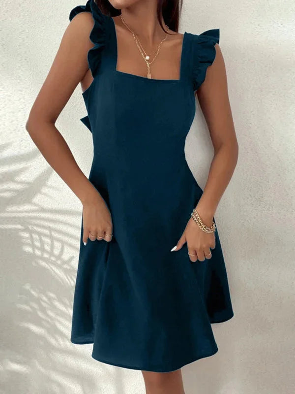 "Viviane flared mini dress in black with ruffle detail, made of lightweight cotton blend for a chic and playful look."