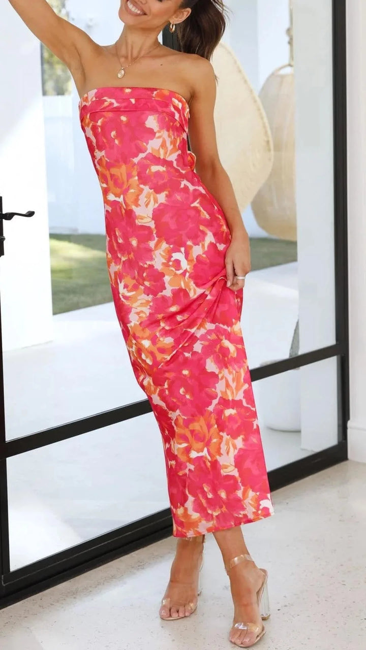 Strapless floral maxi dress in blue and white. Features a fitted silhouette with a delicate floral print, suitable for both…
