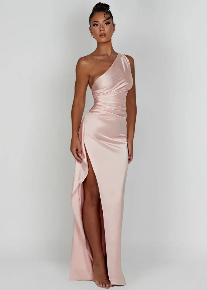 Pink Dottie satin dress with one-shoulder design and slit detail. Silky smooth fabric for a sophisticated evening look.