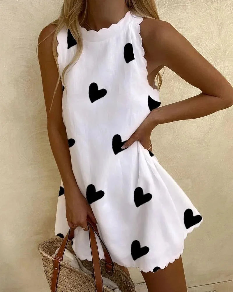 Heart print mini dress with ruffles in vibrant red. Soft and flowy fabric, perfect for a fun and flirty look.