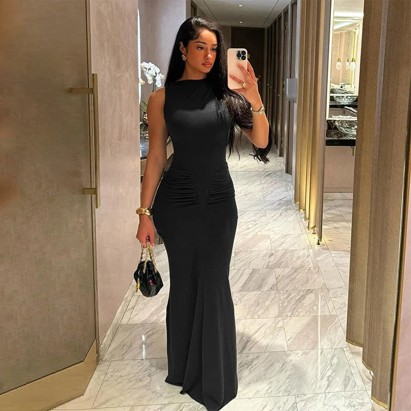 Black sleeveless maxi dress with pleats, tailored fit. Made of lightweight fabric, versatile and elegant for any occasion.