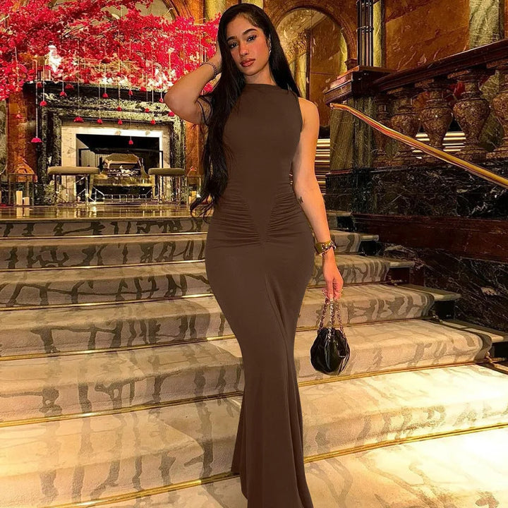 Brown sleeveless maxi dress with pleats, made from comfortable fabric. Fitted silhouette provides a figure-flattering look.