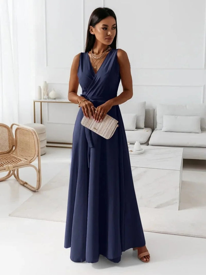 "Navy Blue sleeveless V-neck pleated maxi dress by Winnie, crafted with lightweight flowing fabric for a flattering and…