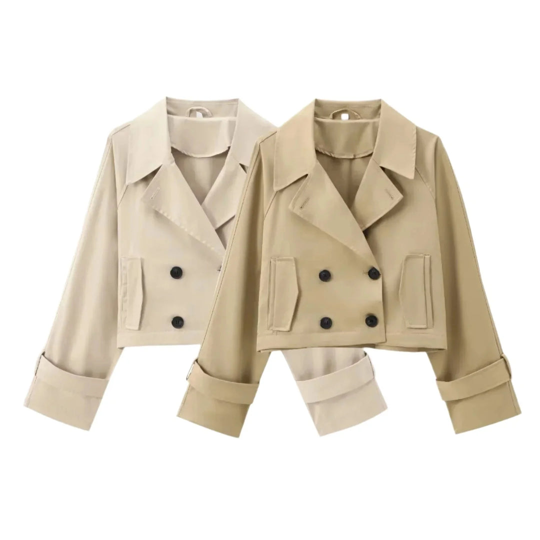 Stylish cropped trenchcoat in neutral color with button detailing, made from durable cotton blend fabric.