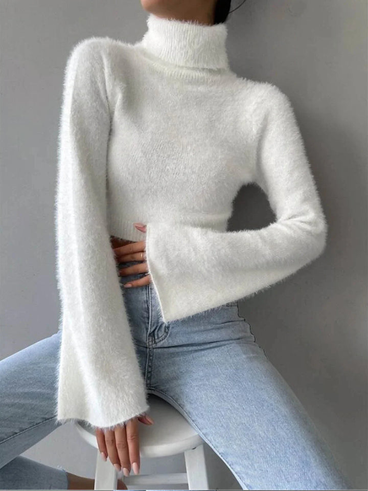 White fluffy cropped turtleneck sweater with cozy knit texture. Stay warm and stylish with this trendy piece by Spencer.