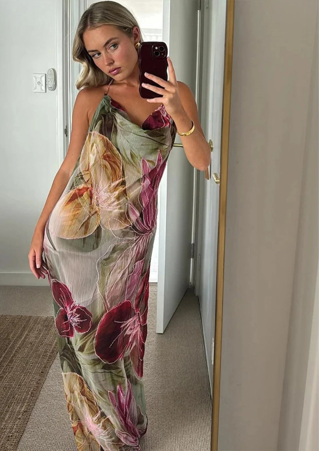 "Sleeveless knee-length dress in Olyvia featuring a vibrant floral design on a lightweight fabric, perfect for warm weather."