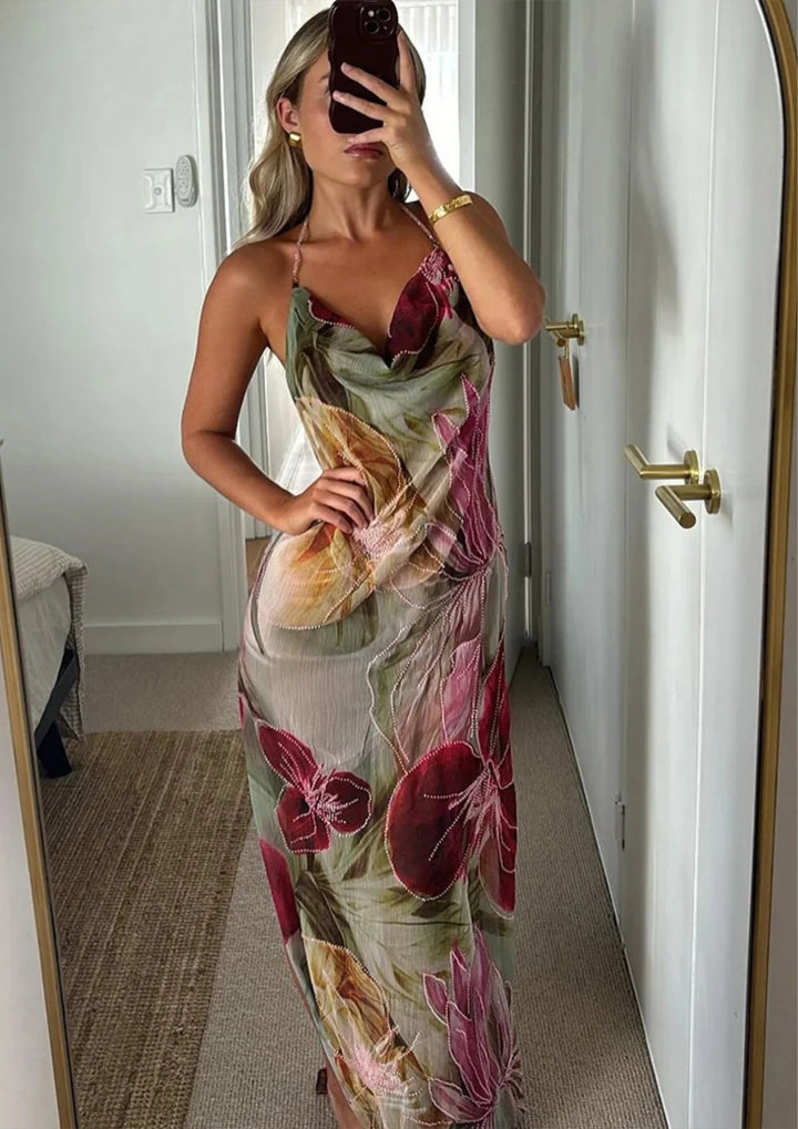 Sleeveless dress from Olyvia with vibrant floral design, perfect for summer days.