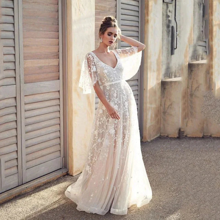 "Lyric ivory maxi dress with flutter sleeves, featuring elegant embroidery, perfect for special occasions or casual chic…