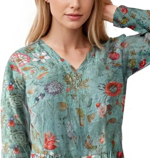 Teal floral maxi dress with long sleeves, featuring a flowy design with a vibrant teal color and elegant floral pattern.