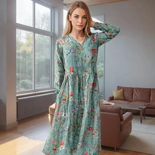 Teal floral maxi dress with long sleeves showcasing a Avanna botanical design on soft flowing fabric.