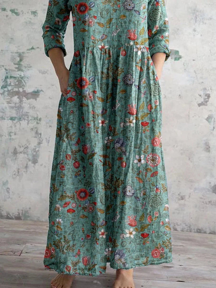 Teal floral maxi dress with long sleeves, featuring a vibrant design perfect for a stylish and chic look.