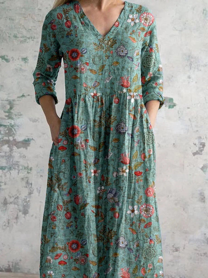 Teal floral maxi dress with long sleeves, featuring intricate floral pattern in a flowy fabric perfect for day or evening…