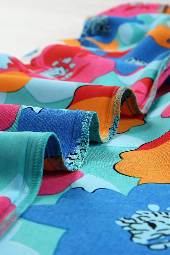 "Adria dress in v-neck shift style with floral pattern, made of soft cotton blend fabric in shades of blue and pink."