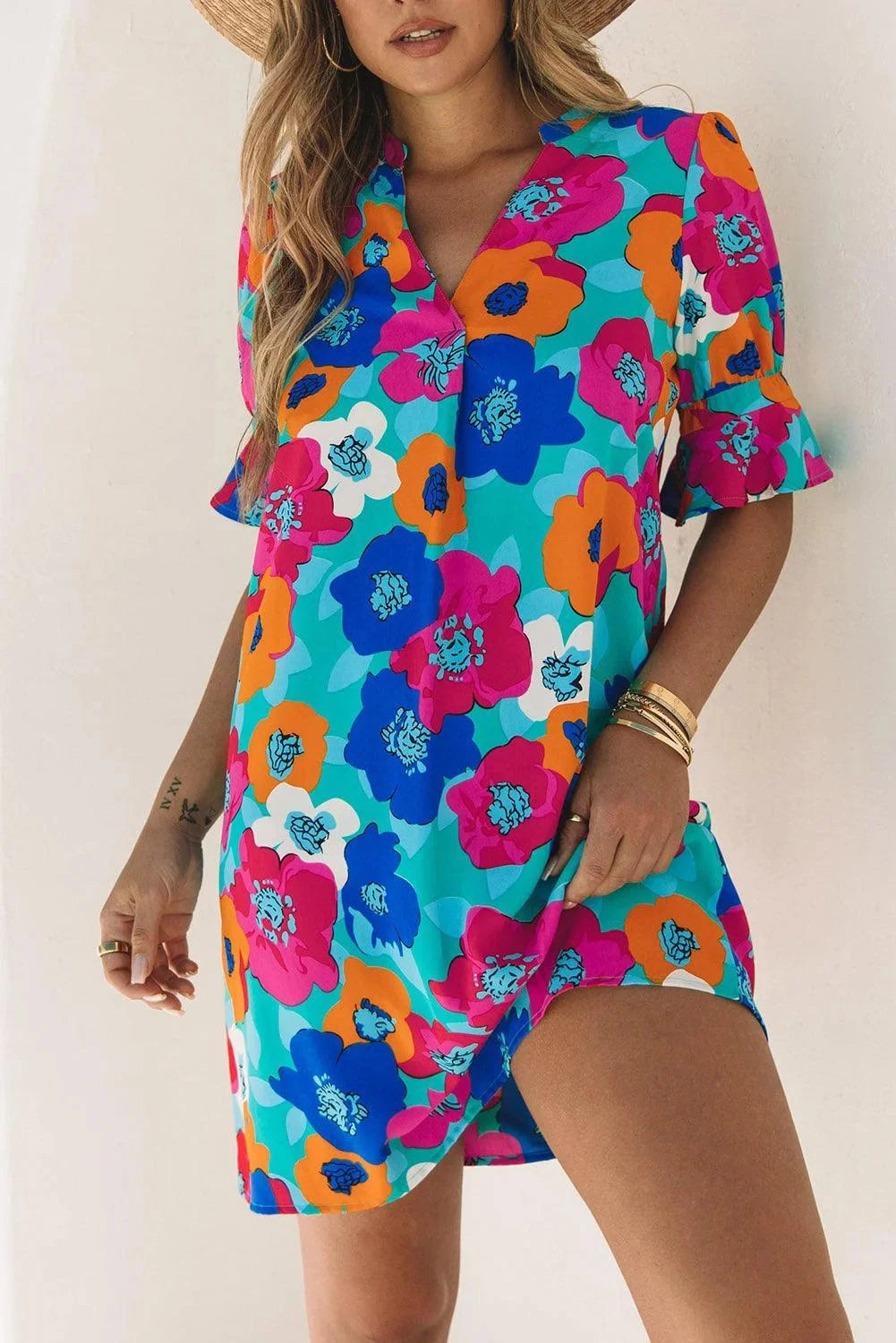 "Adria shift dress in V-neck silhouette with floral print, made of lightweight fabric for a casual chic look."