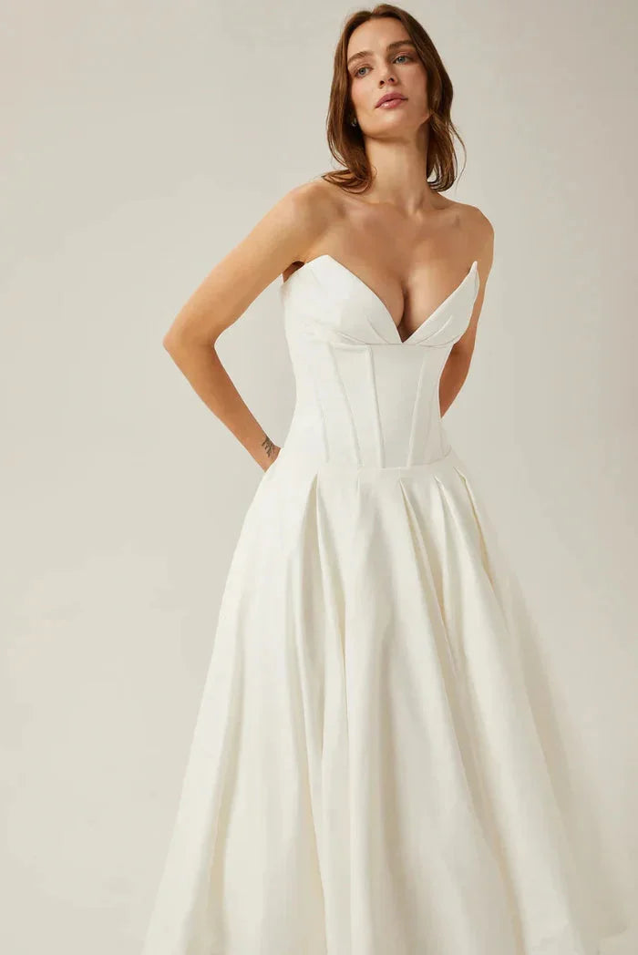 Strapless corseted A-line midi dress by Camryn, featuring a structured silhouette with floral print and sweetheart neckline.