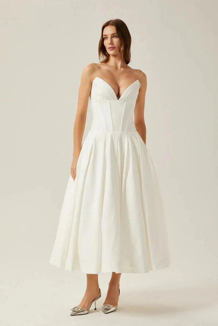 "Camryn Strapless Corseted A-line Midi Dress in ivory satin fabric with lace detailing and elegant silhouette."