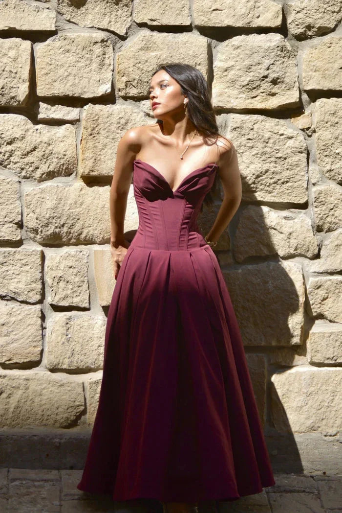 Wine Red Camryn strapless corseted A-line midi dress with a structured design and flattering silhouette perfect for formal…