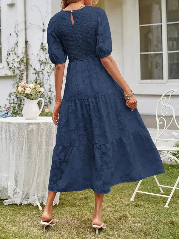 "Emily floral midi dress with textured tiers in a soft fabric, perfect for casual or semi-formal occasions."