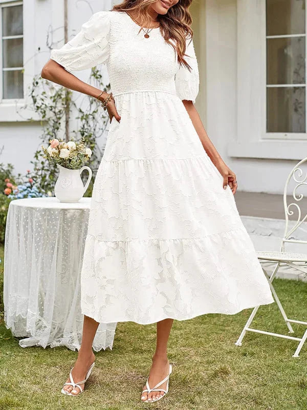 "Emily midi dress with floral textured design, tiered style, perfect for any occasion."