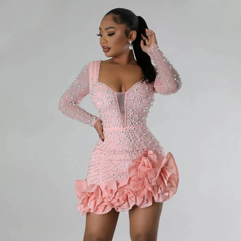 Pink mini dress with ruffles and embellishments by Cali. Perfect for a feminine and stylish look, made with high-quality…