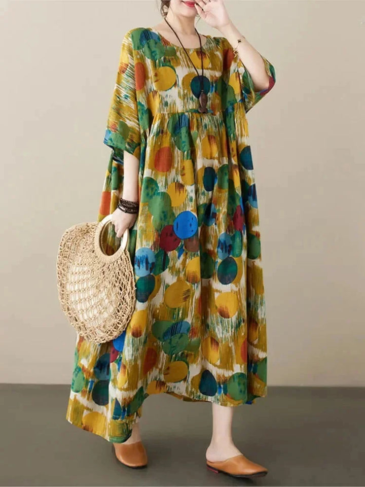 "Flowy boho maxi dress with artistic prints, perfect for summer. Features lightweight, breezy fabric and vibrant patterns."