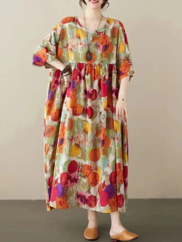 Red boho maxi dress with artistic prints featuring a flowy silhouette. Made with soft, breathable fabric for a comfortable…