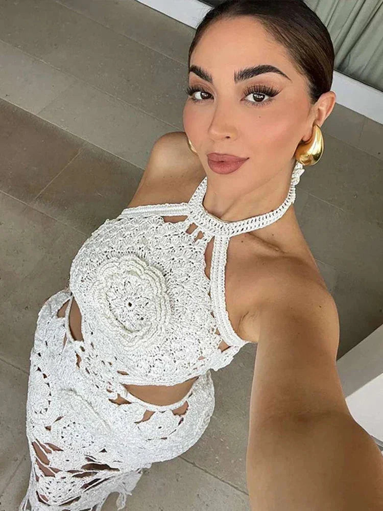Sleeveless white crochet maxi dress by Ellinor, featuring intricate crochet details and a flowing silhouette.