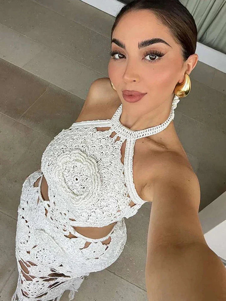 Sleeveless white crochet maxi dress by Ellinor, featuring intricate crochet details and a flowing silhouette.