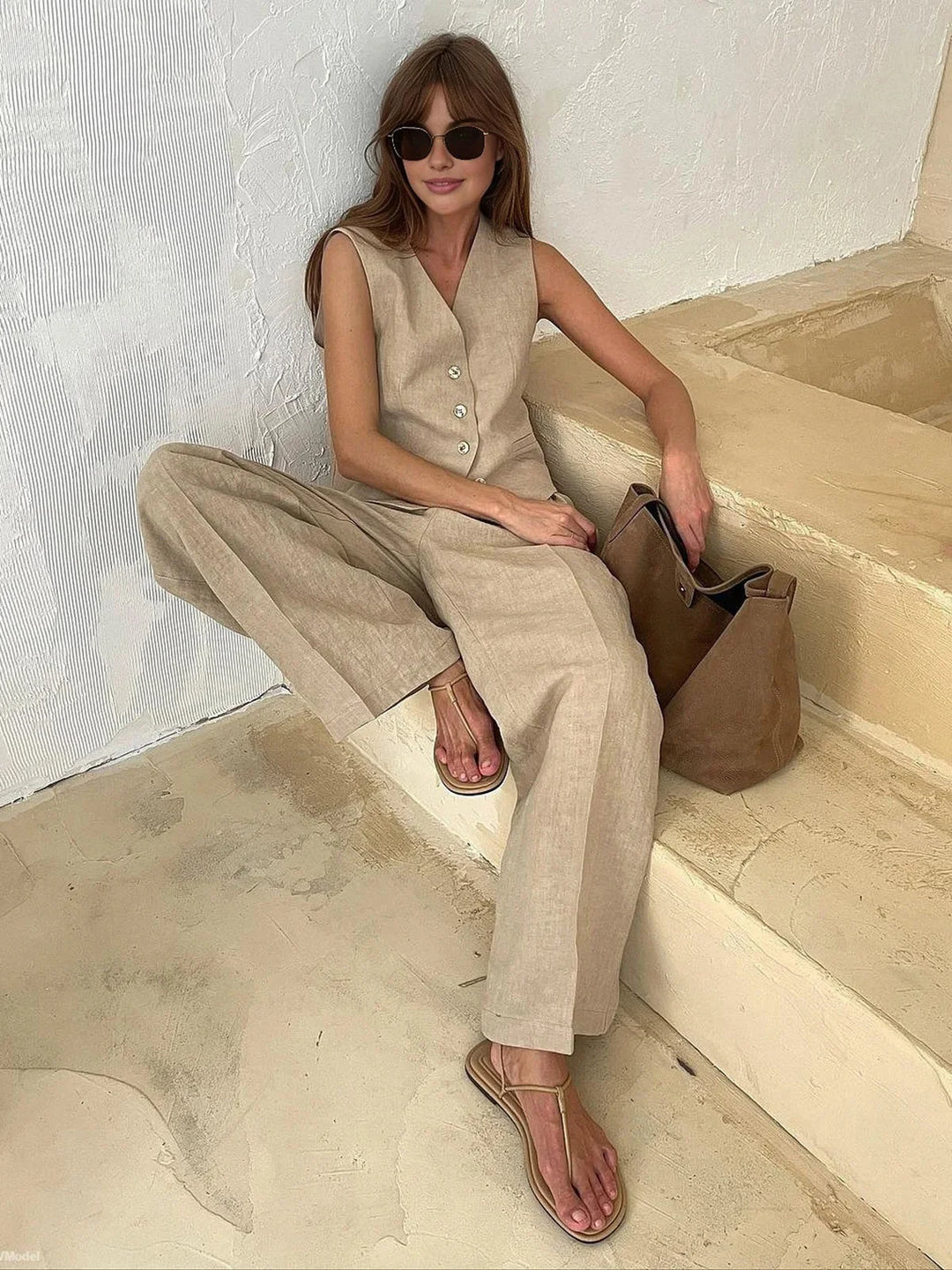 Sleeveless top and wide-leg pants set in Beautiful material, perfect for a chic and sophisticated look.