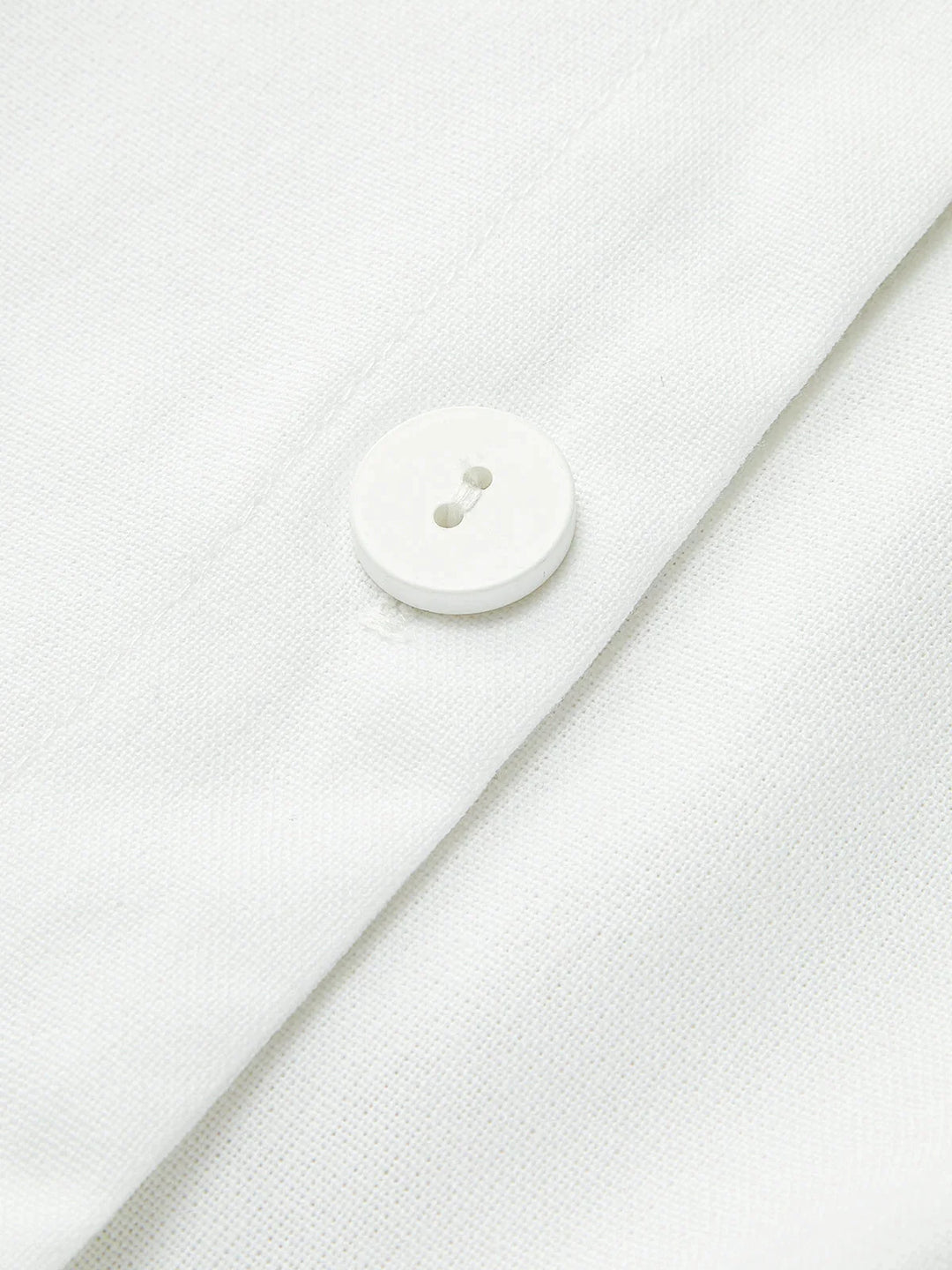"Sleek sleeveless button-up collared shirt in soft cotton blend with modern design and versatile style by Noemi"