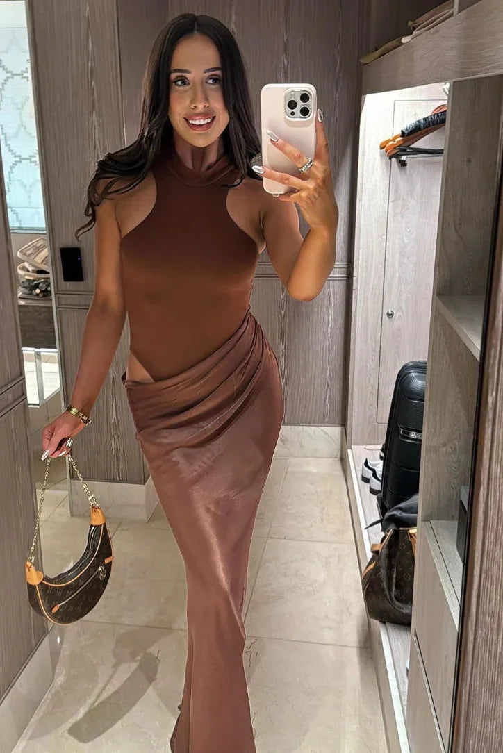 Sleek chocolate evening dress by Rowyn, featuring a shimmering satin fabric and a stylish silhouette for a sophisticated…